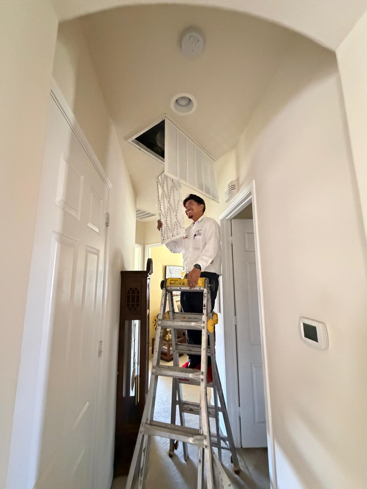 Sanborn's certified technician performing HVAC maintenance