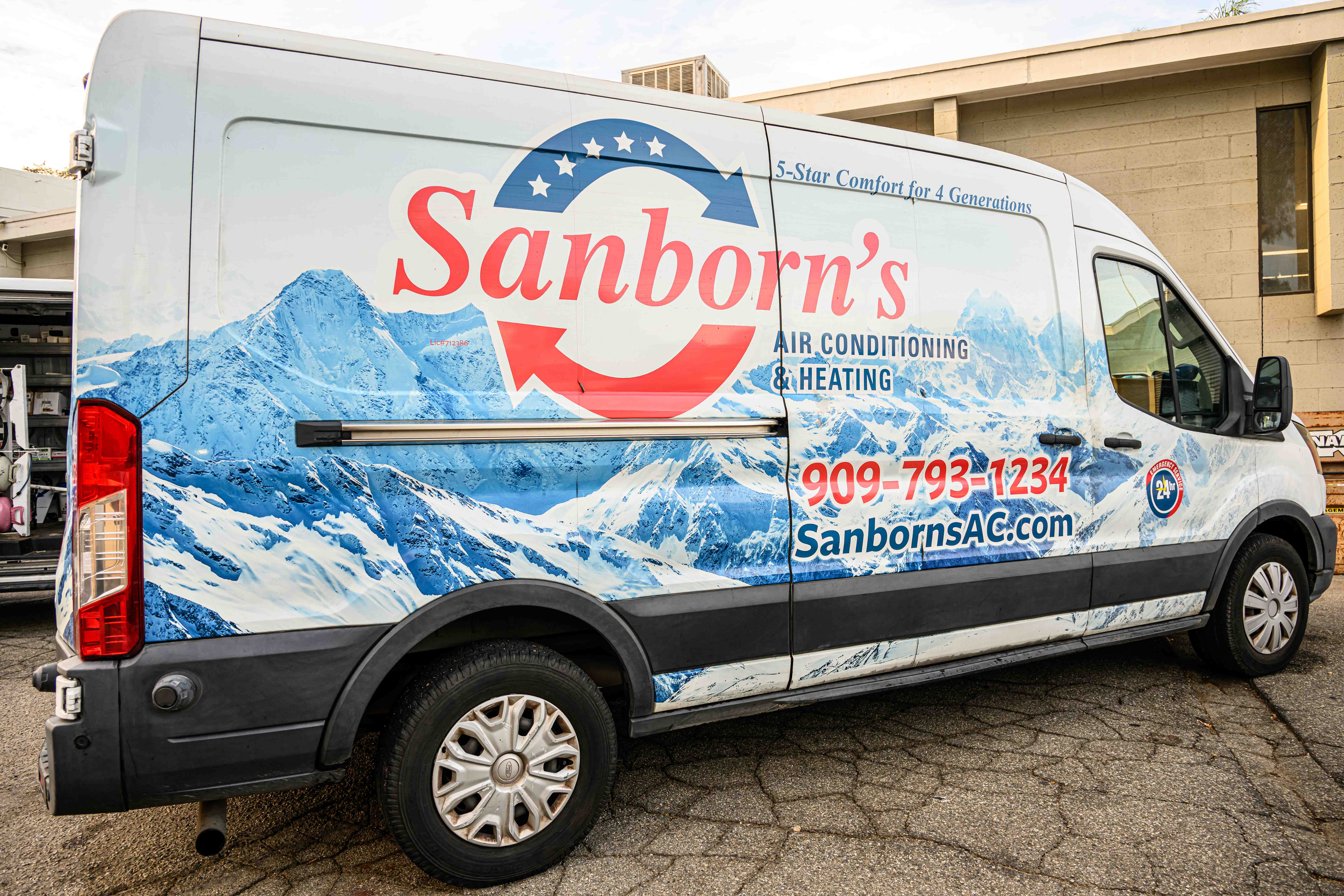 Sanborn's certified technician performing HVAC maintenance